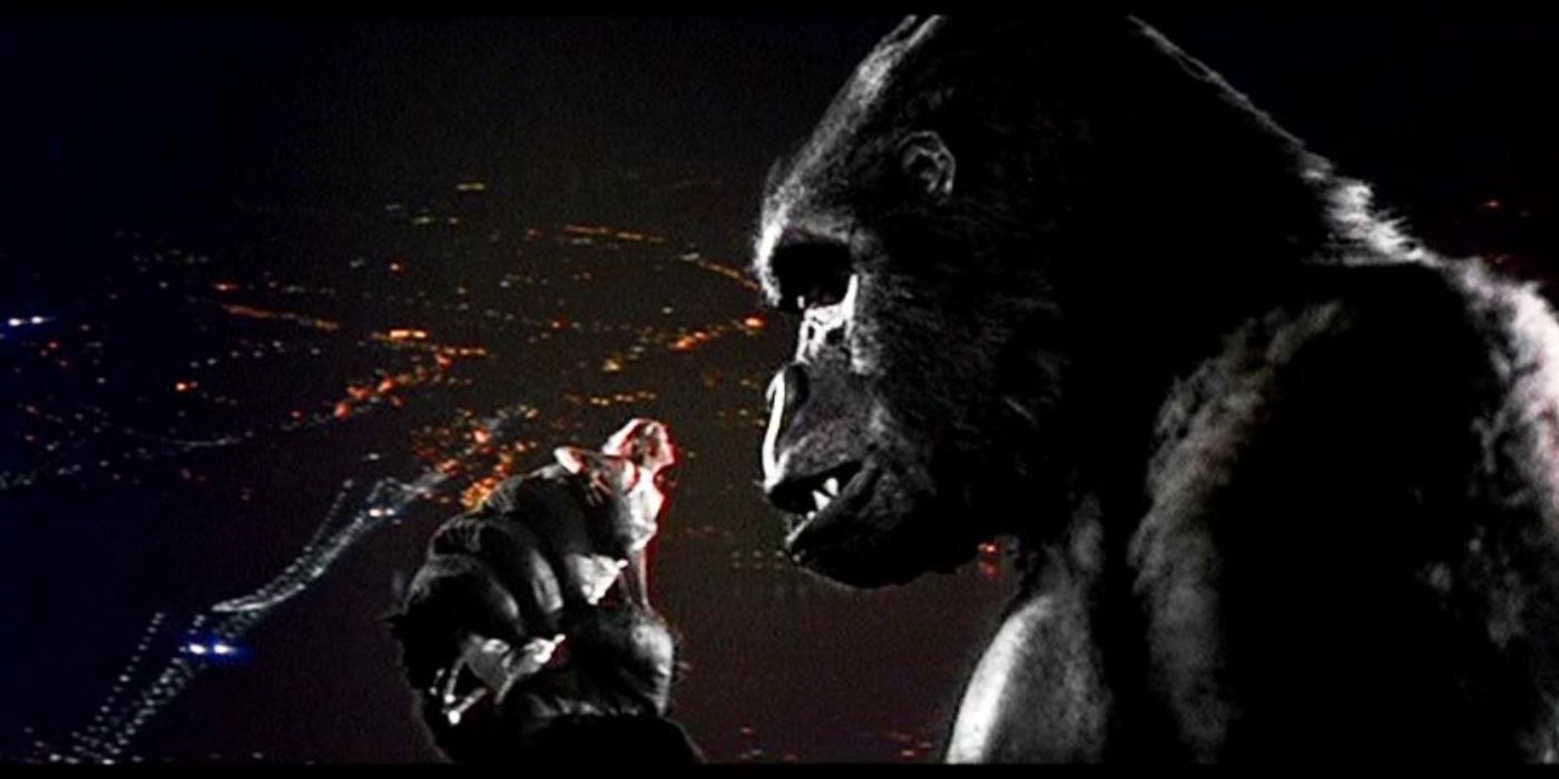 King Kong - the 1976 version - holds up a woman in a white dress to his face.