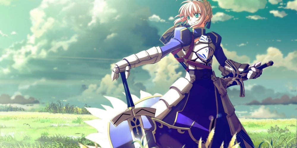 Saber posing with her sword in a grassy field in Fate/Stay Night.