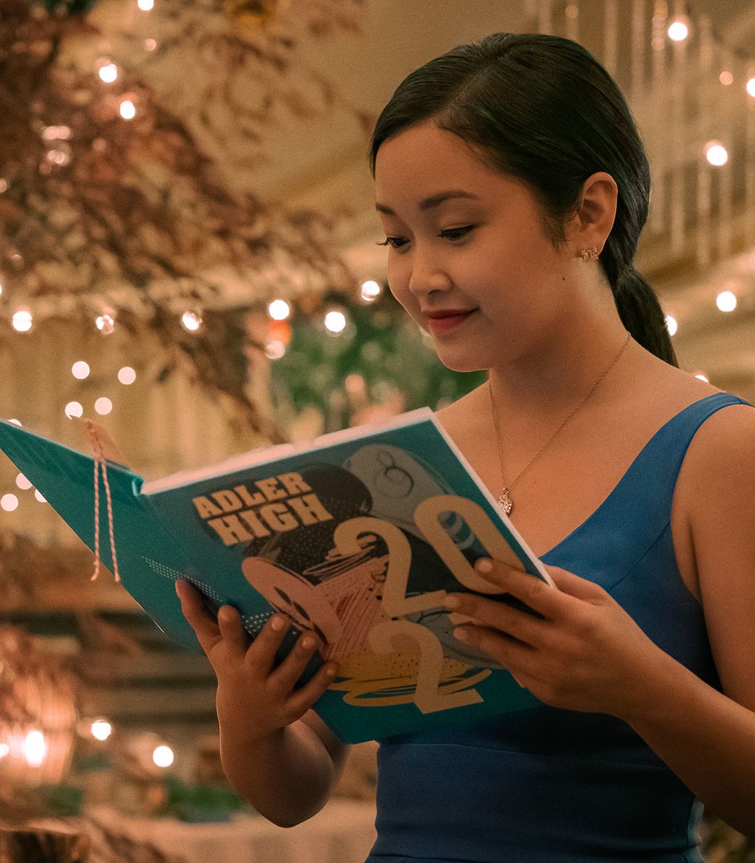 Lara Jean looks at her yearbook in To All the Boys I've Loved Before: Always and Forever