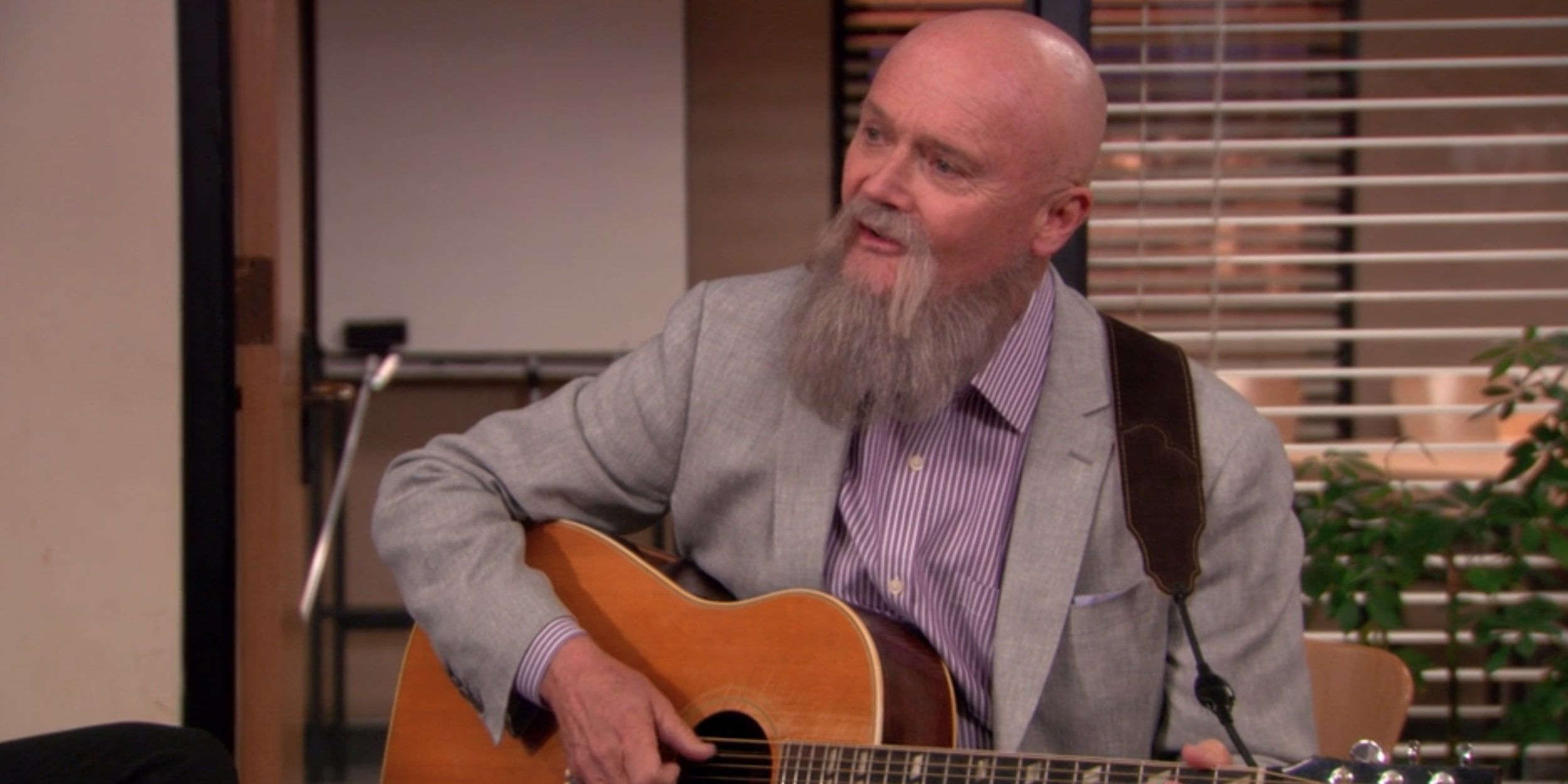 Creed Bratton playing guitar on The Office