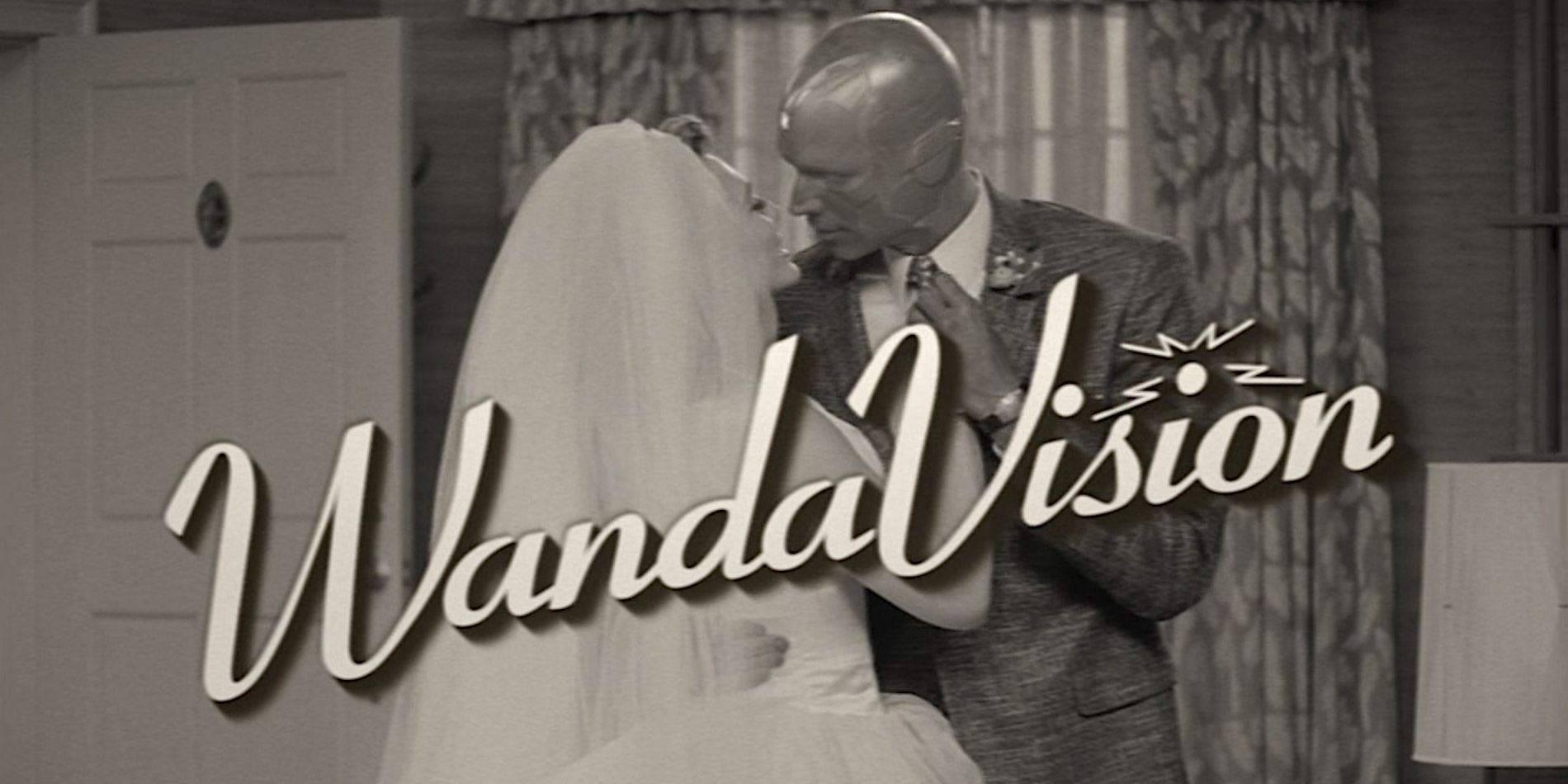 Wanda and Vision kissing, both dressed in traditional marriage attire. A title splash over the middle of the screen says &quot;WandaVision&quot;