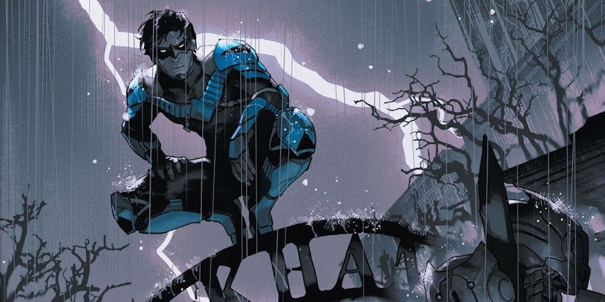 Nightwing perched on top of the Arkham Asylum sign