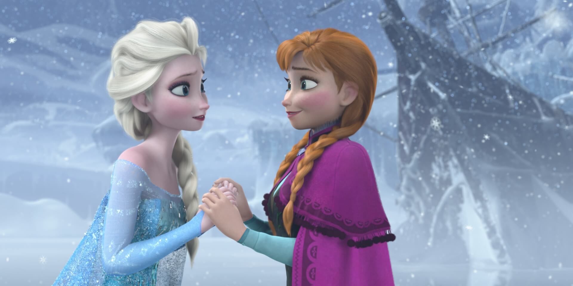 Anna and Elsa holding hands in Frozen.