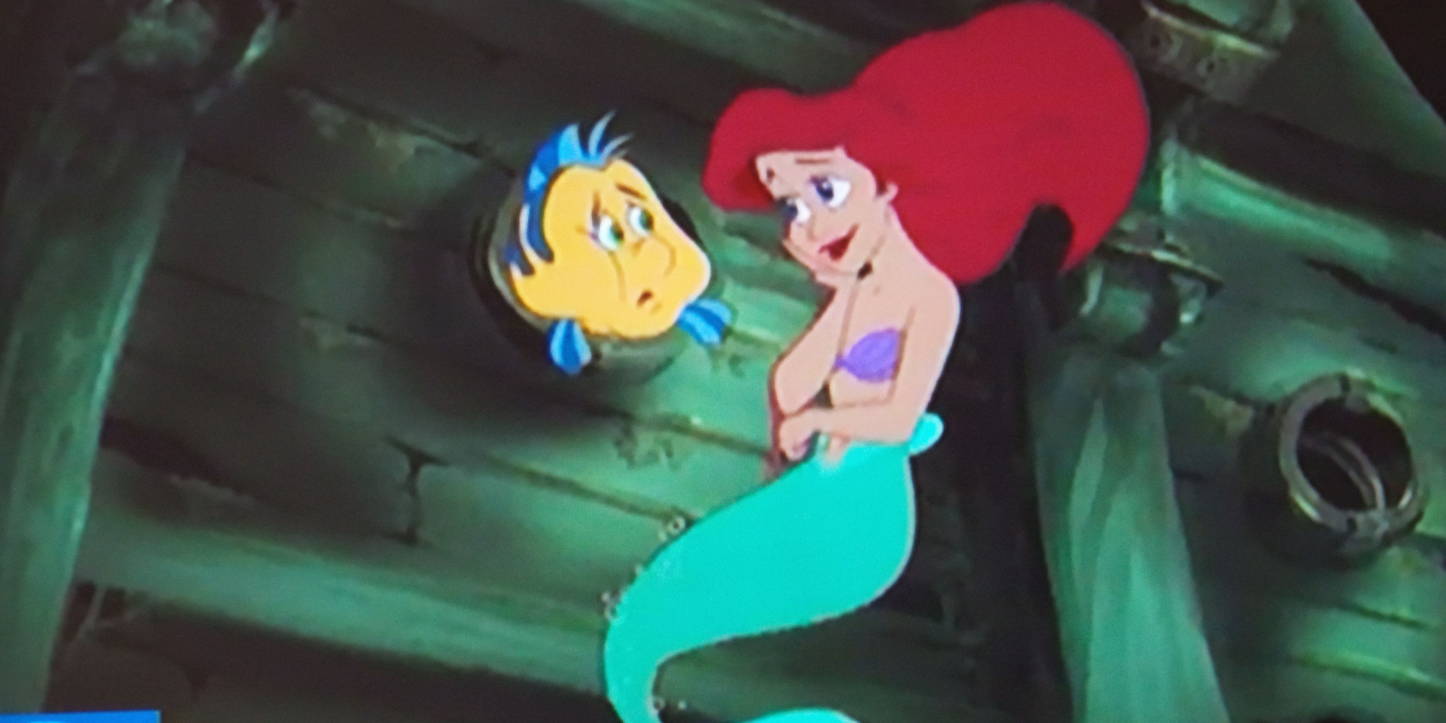 Ariel and Flounder from The Little Mermaid in the wreckage of the ship