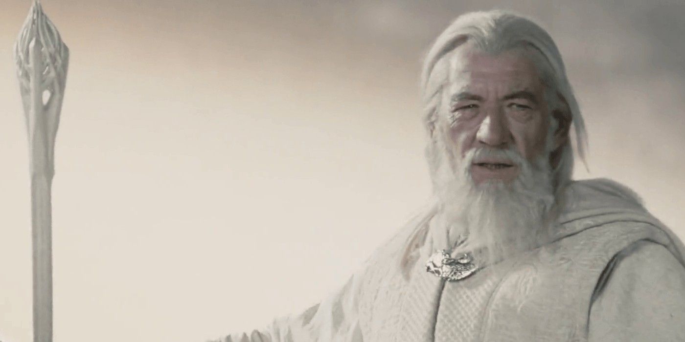 Gandalf the White standing in the mist with his staff on the left in Lord of the Rings.