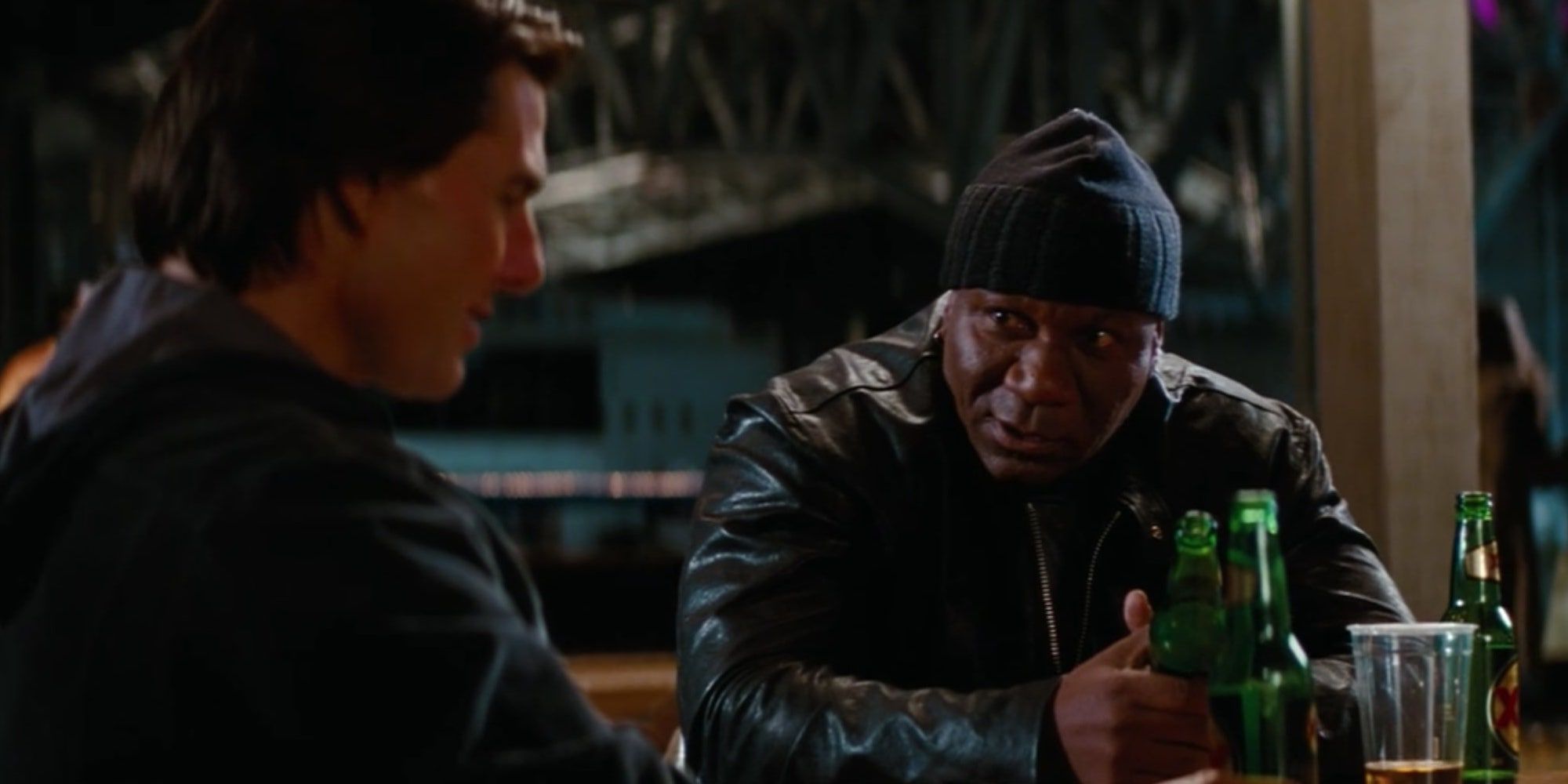 Ethan Hunt sits with Luther Stickell at a table, drinking beer