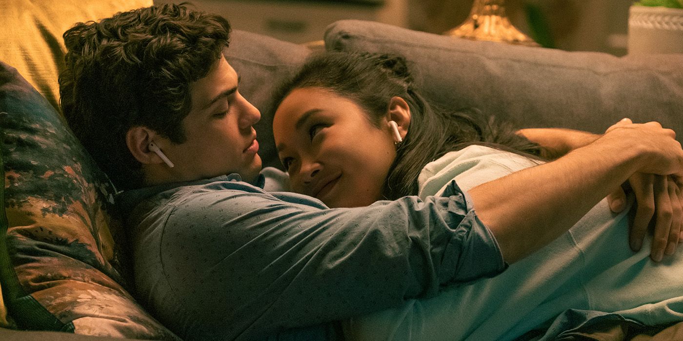 Peter and Lara Jean cuddle on the couch in To All the Boys I've Loved Before: Always and Forever