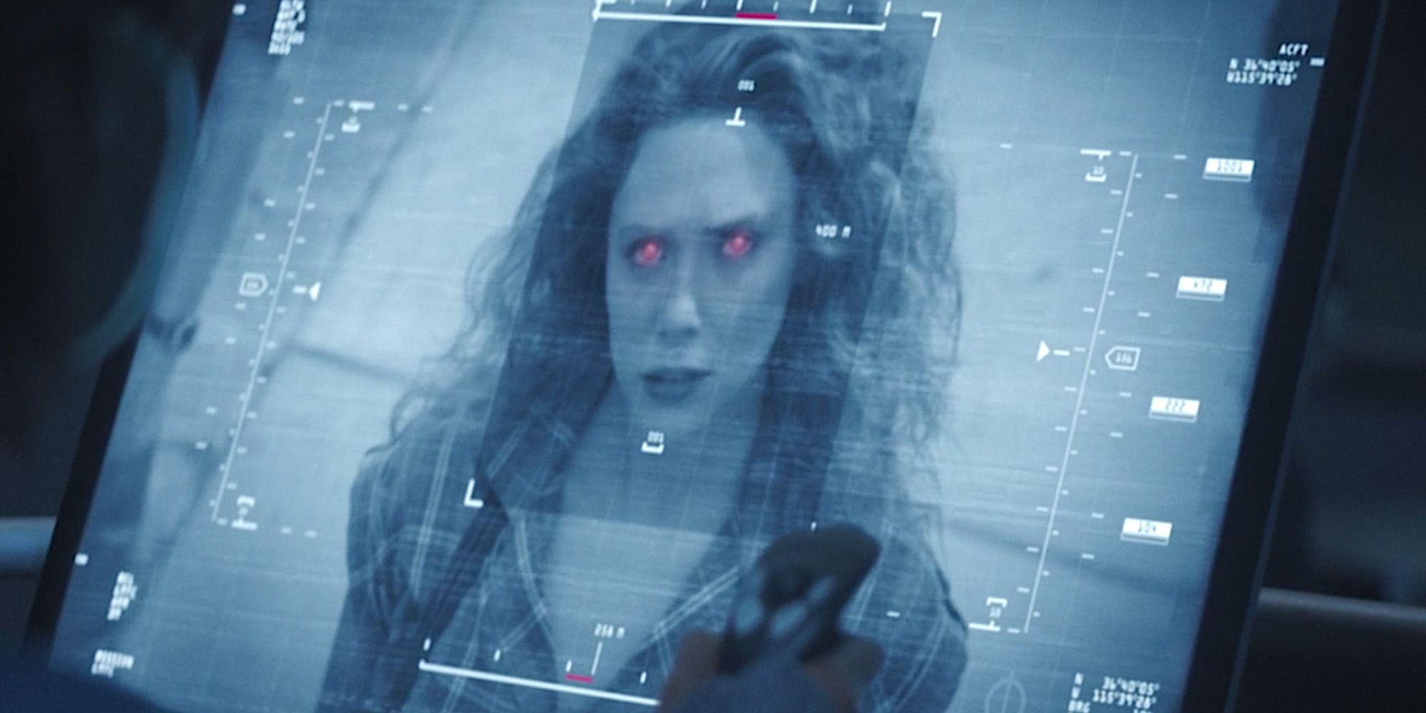 Wanda being viewed through a black-and white military display, as she stares directly into the camera, with glowing red eyes