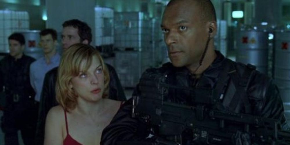 Alice and Umbrella Corp walking through the facility in Resident Evil