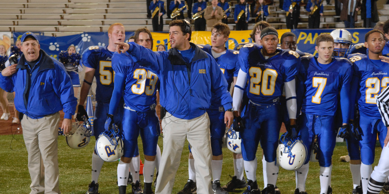 Eric Taylor coaches his football players on the field on Friday Night Lights