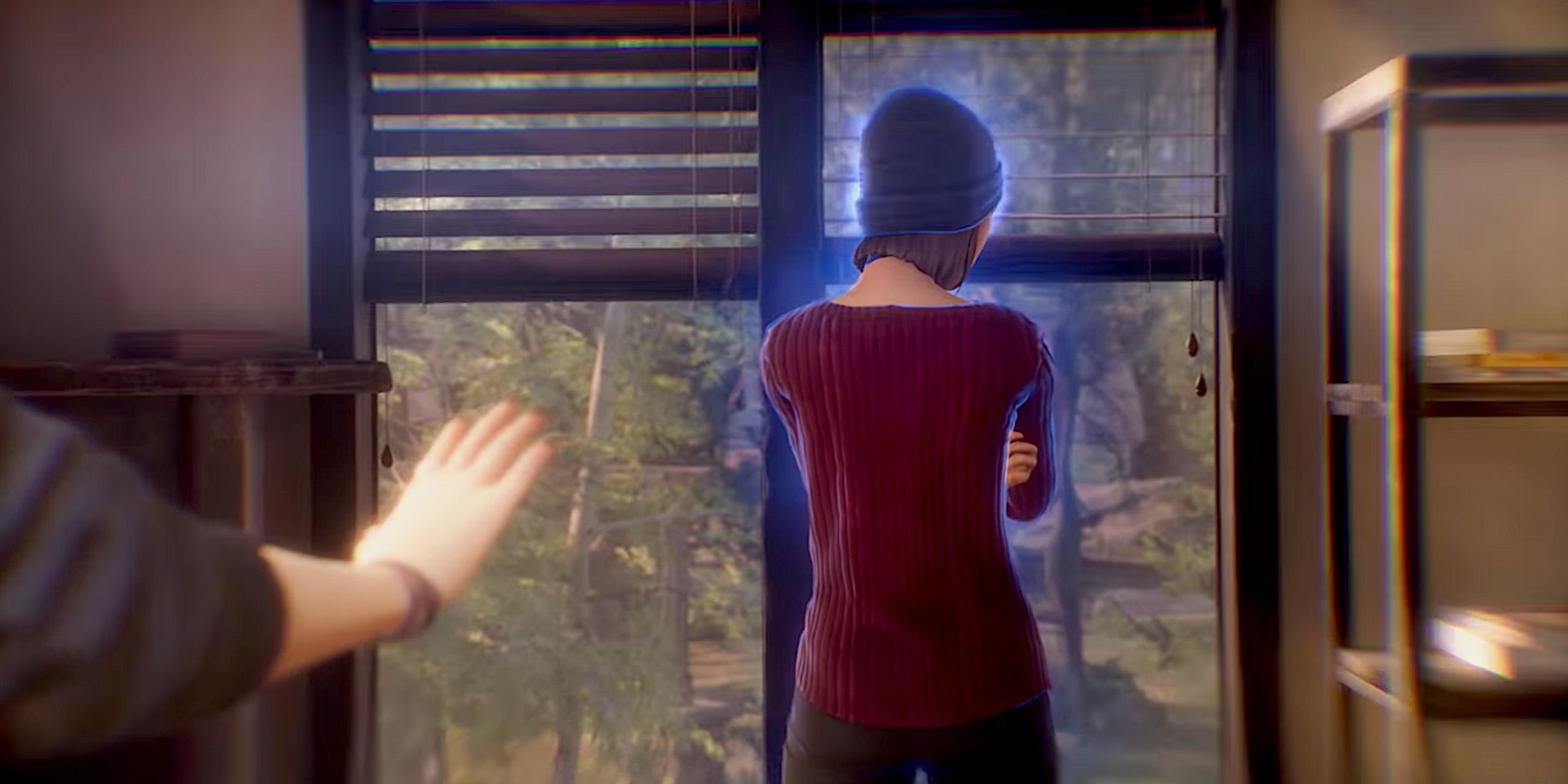 Steph, a young woman with a dark blue beanie and a red shirt, turned away from the viewer. She's surrounded by a hazy blue aura.