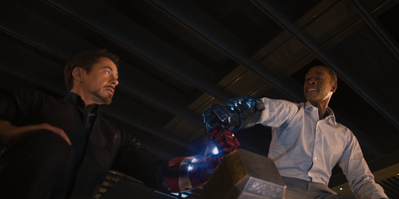 Tony Stark and Rhody try to lift Thor's hammer