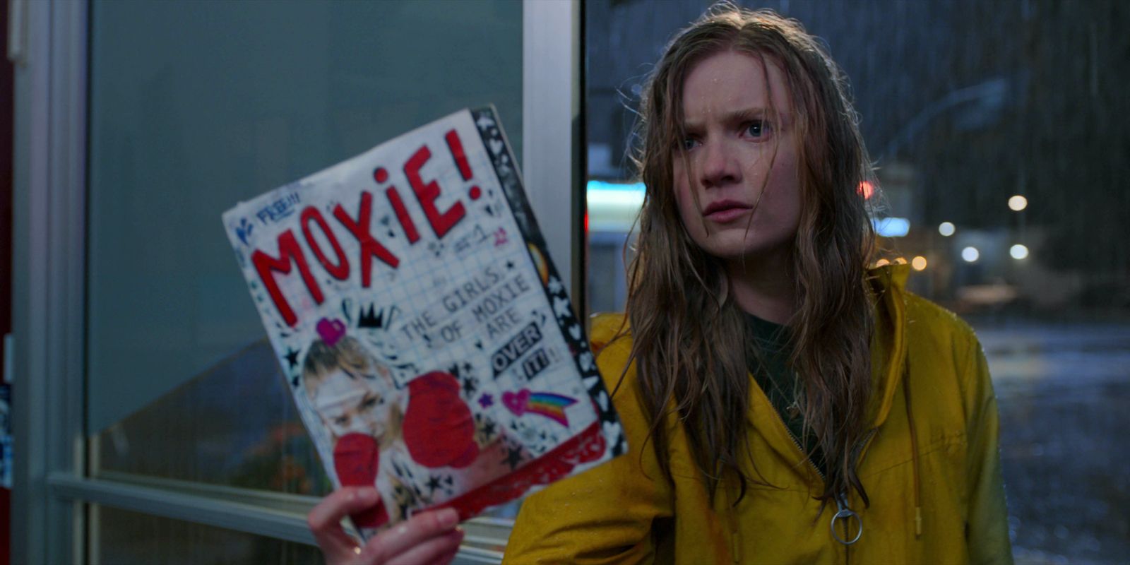 Vivian holds up an issue of her zine in Moxie.
