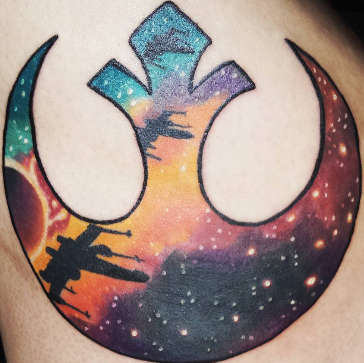 The Rebel Alliance symbol with a galaxy as the background