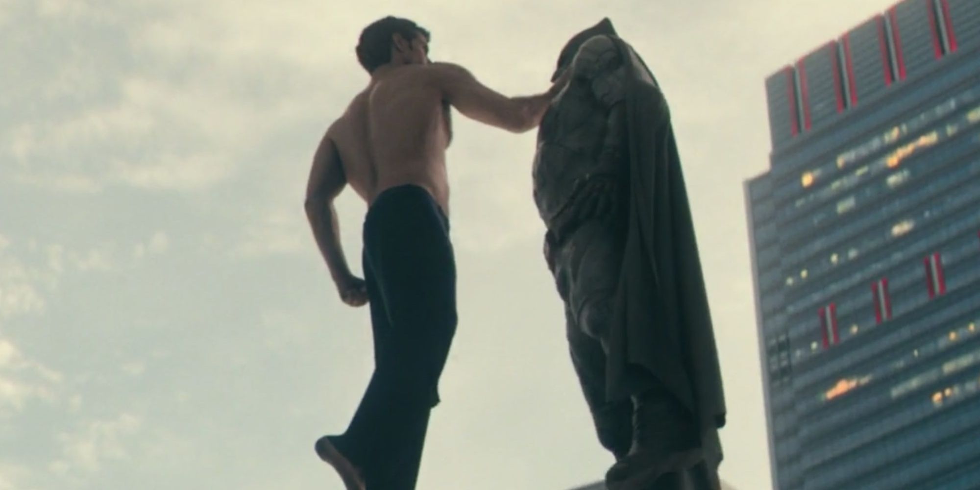 Superman choking Batman midair
