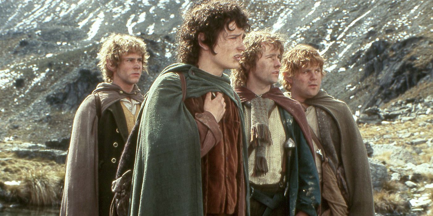 The Hobbits Frodo, Samwise, Peregrin and Meriadoc standing by a mountain