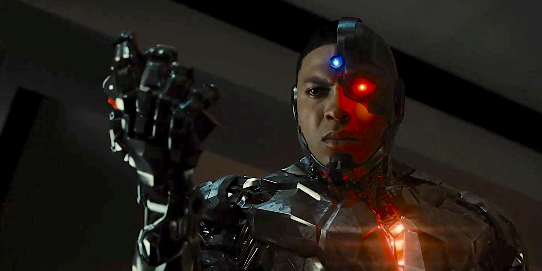Cyborg holding up his first and crushing his father's tape recorder