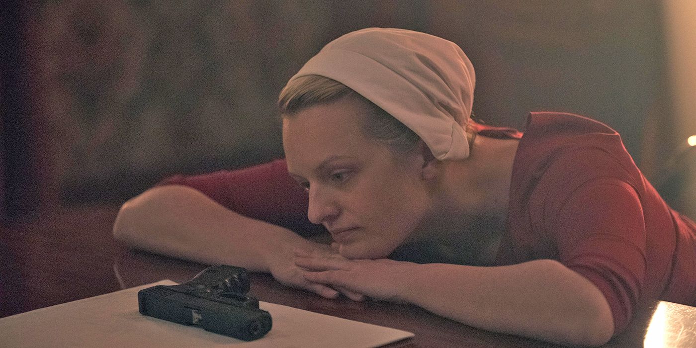 the handmaid's tale June with a gun on the table
