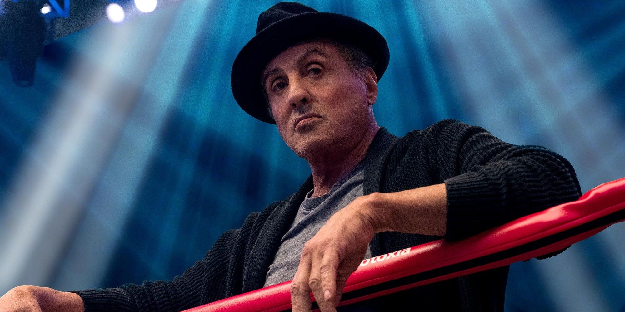 Sylvester Stallone hangs out on the top rope of a boxing ring in Creed 2