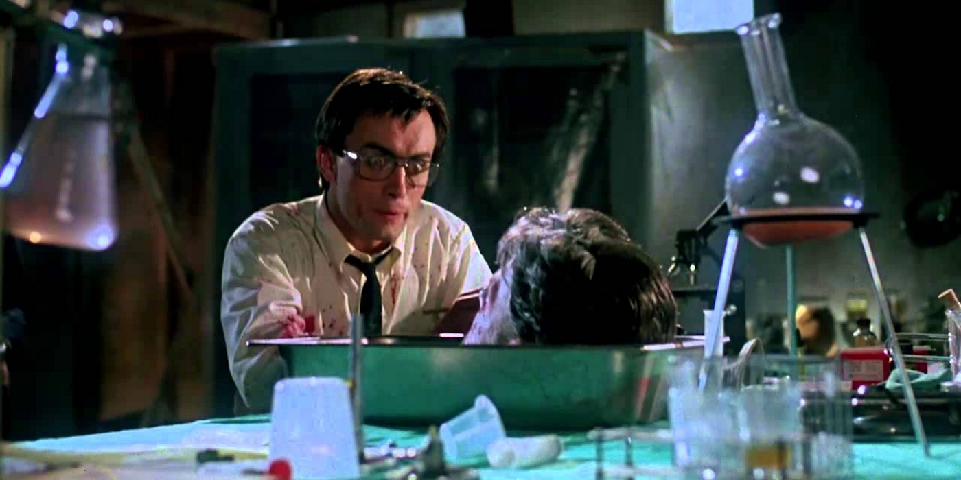Herbert West looks at a head in Re-Animator