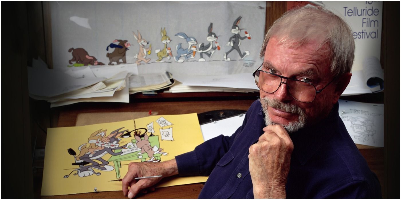 chuck jones looks behind his chair with a finger on his chin