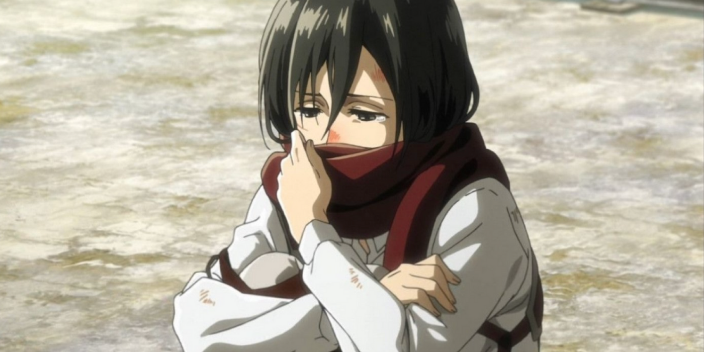 Mikasa holding her scarf in Attack on Titan.