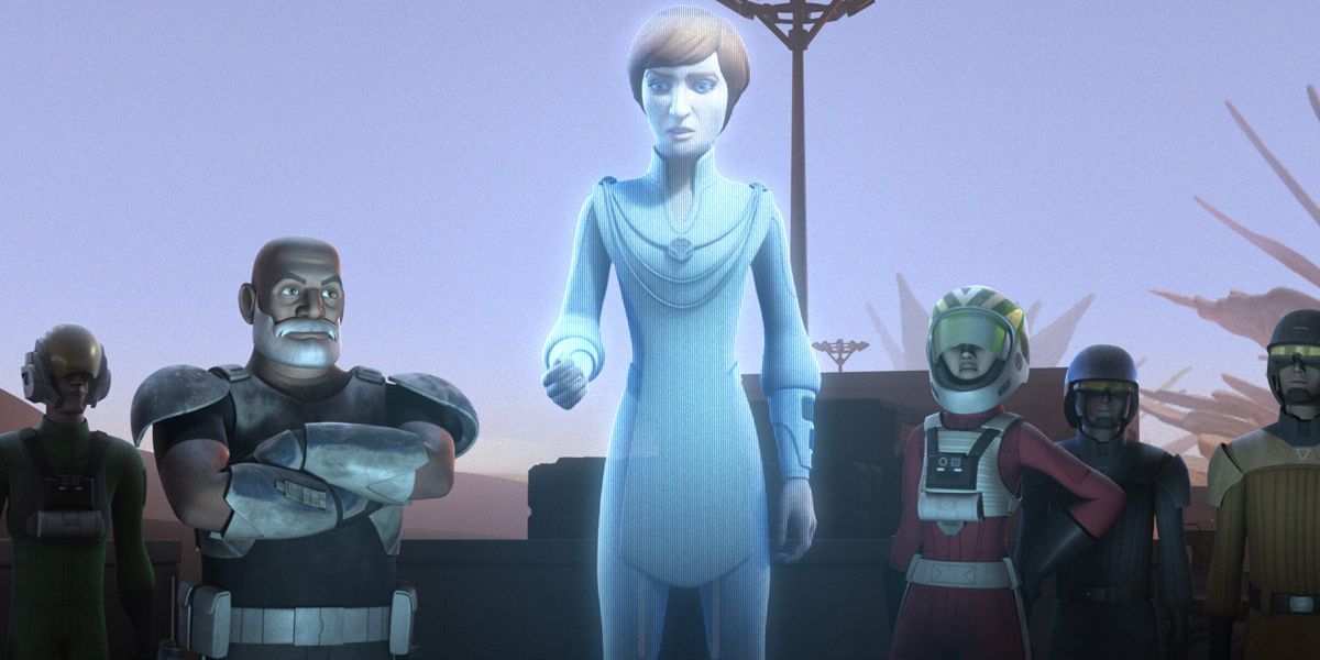 A group of rebels are gathered around a hologram of Mon Mothma