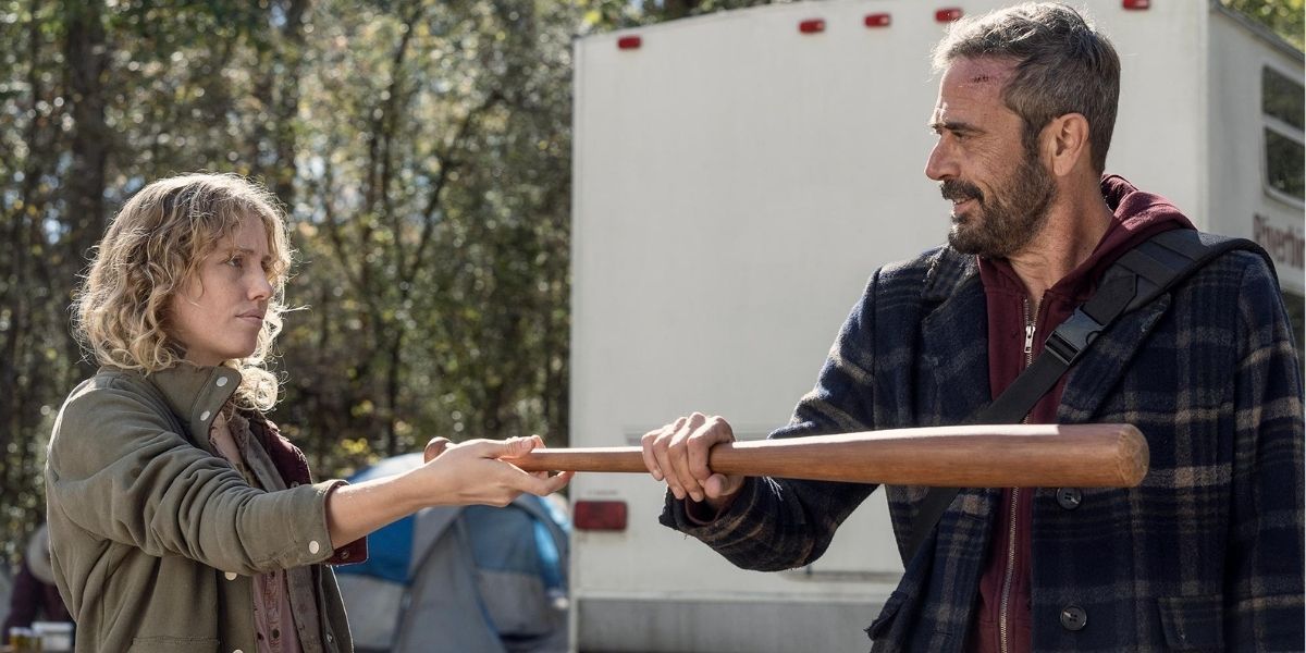 Negan handing Laura a bat in a scene from his flashback episode on The Walking Dead.