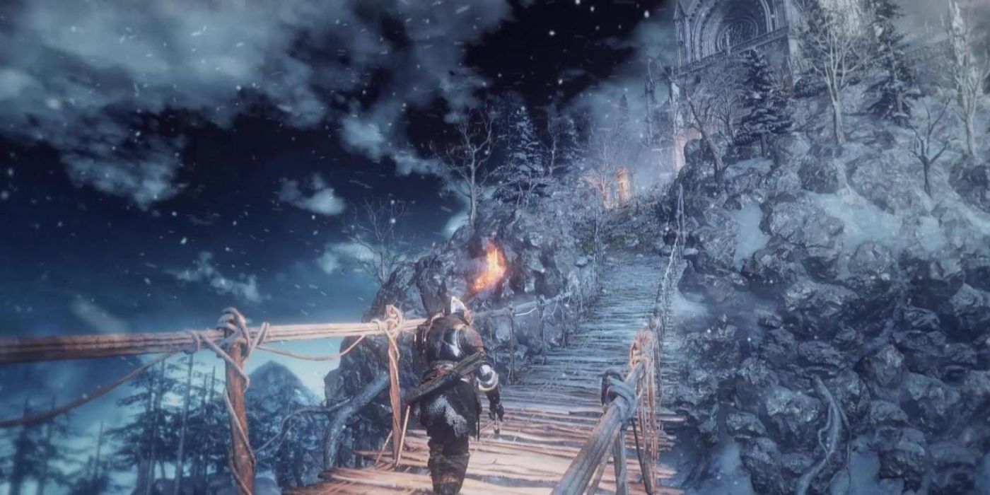 The Ashen One crosses a bridge in the Ashes of Ariandel DLC for Dark Souls III.