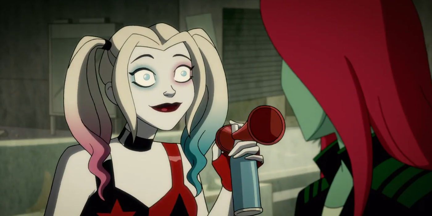 Harley Quinn stands with a smile on her face and an airhorn in her hand, talking to Poison Ivy, who we see from the back.