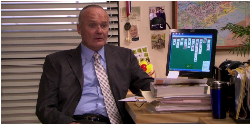 Creed Bratton at his desk in The Office