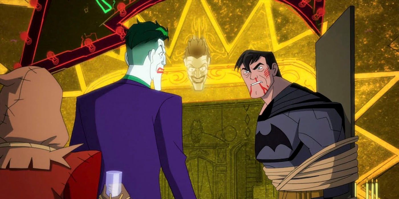 Batman is unmasked and tied up in the Joker's golden lair while the Joker stares at him, unhappily and Scarecrow cowers behind Joker.