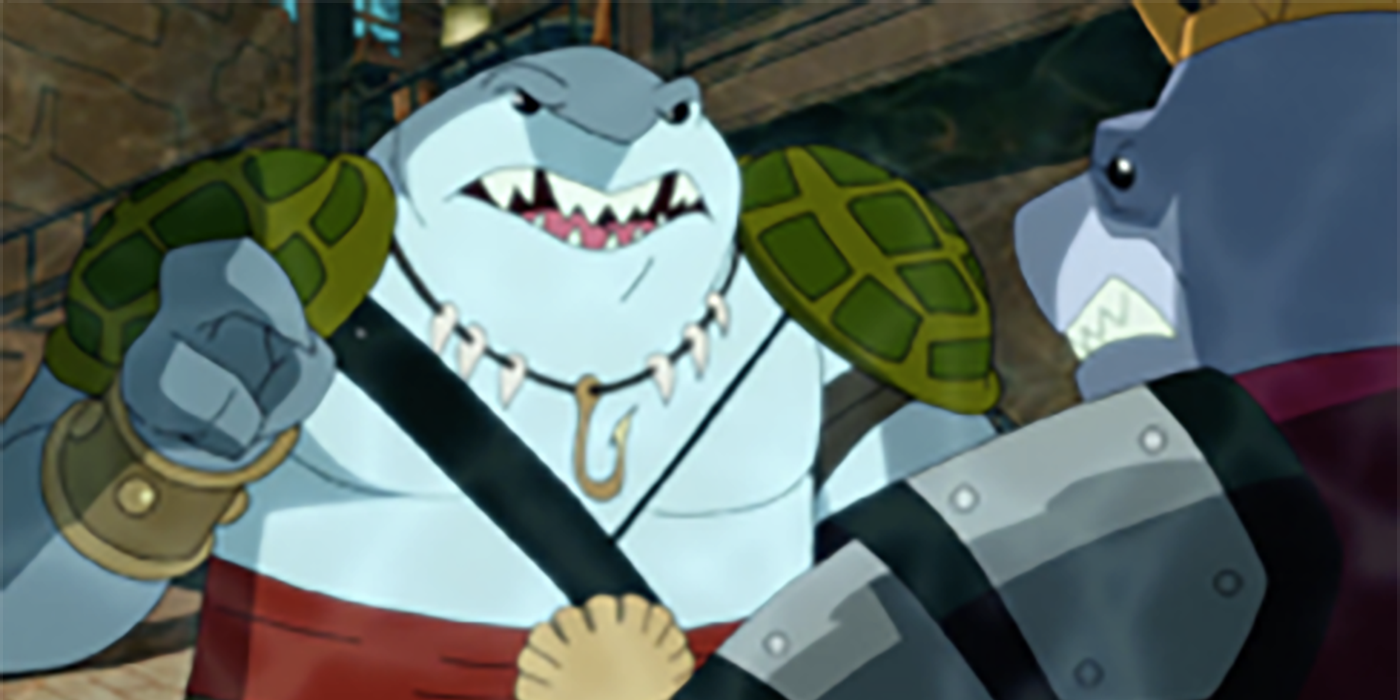 King Shark (a half man-half shark creature) points a finger at another shark creature, his father.