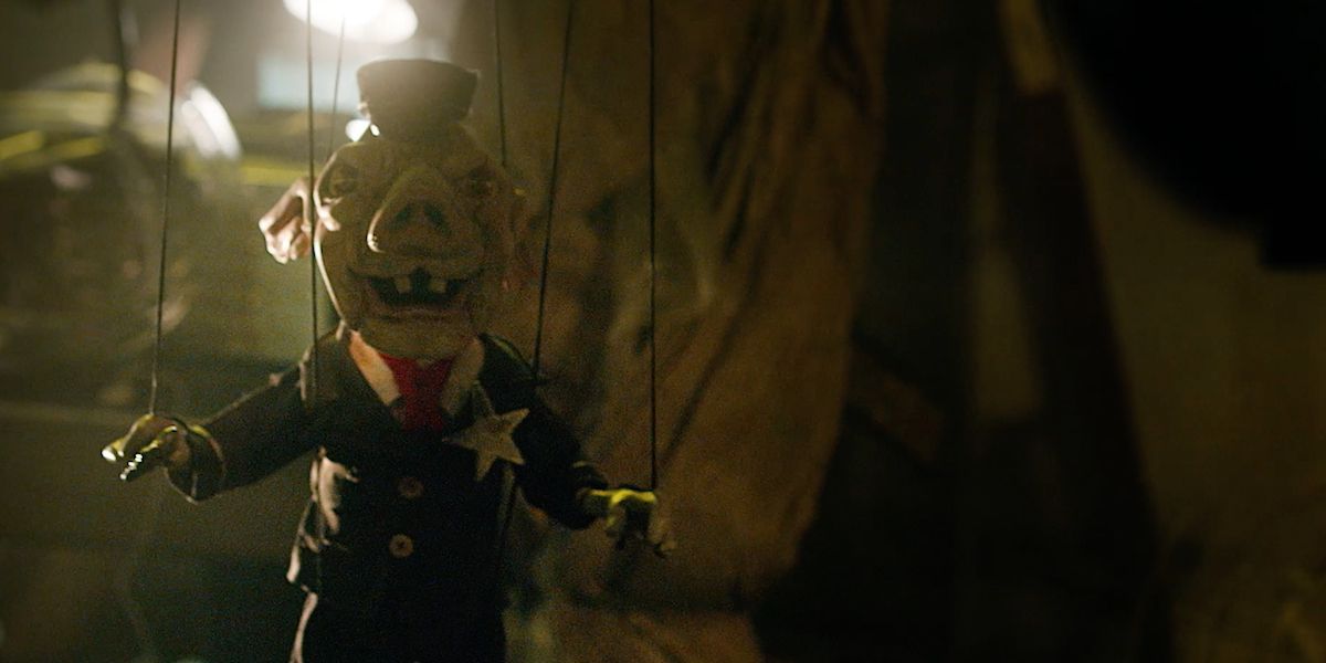 A pig marionette taunts victims in Spiral: Book Of Saw