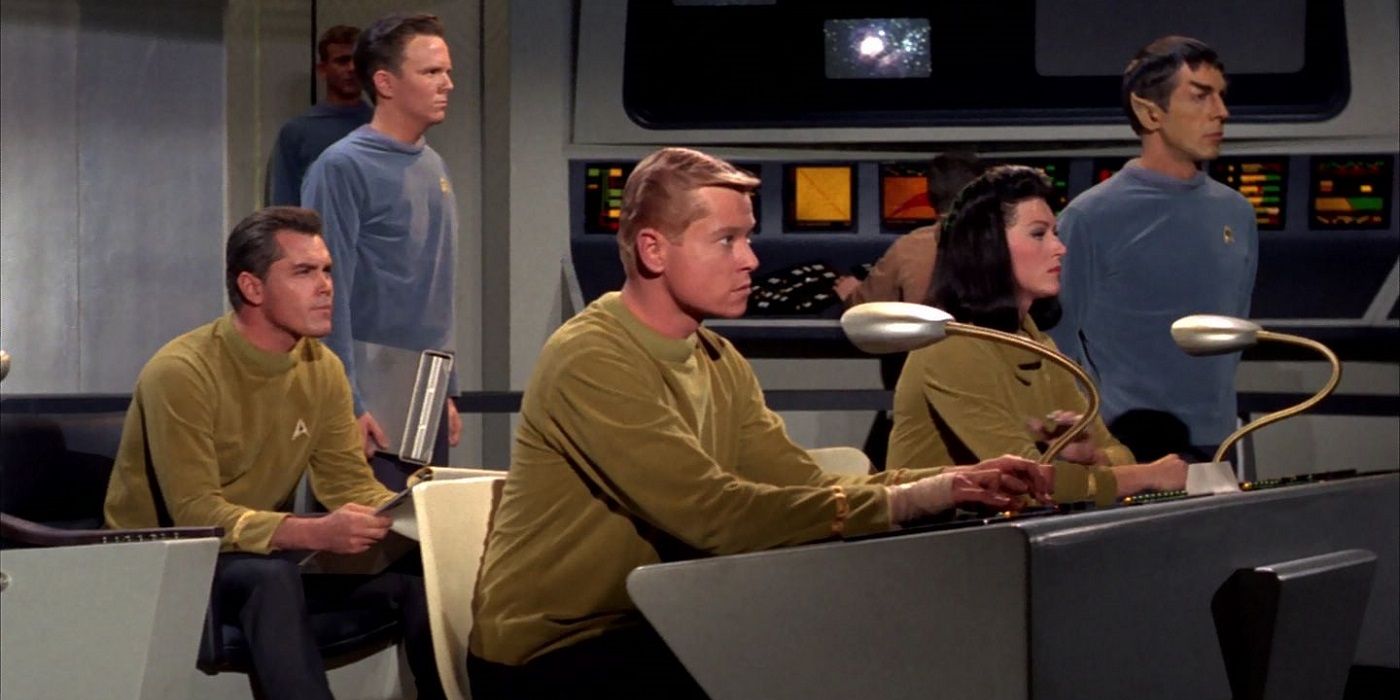 Captain Pike (Jeffrey Hunter), Number One (Majel Barrett-Roddenberry), and Mr. Spock (Leonard Nimoy) on the bridge of the USS Enterprise in the Star Trek original pilot, "The Cage"