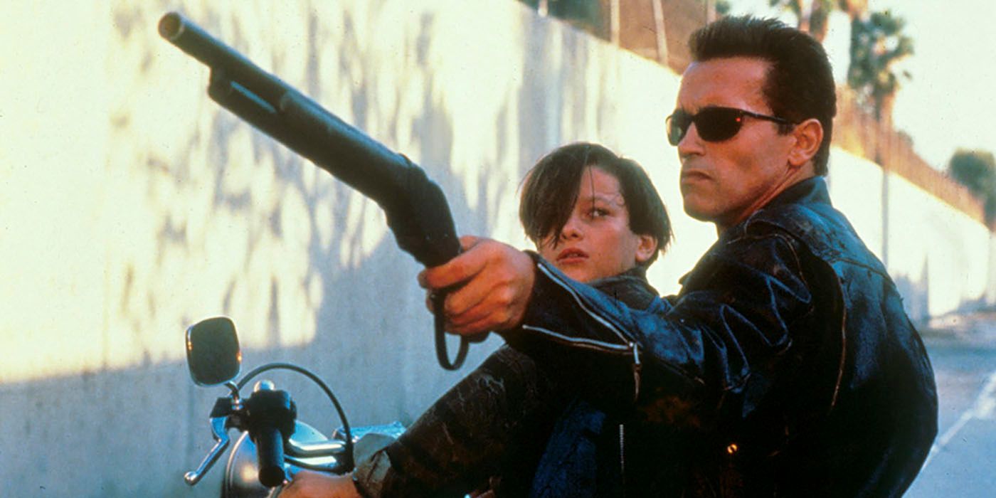 The terminator and John Connor sit on a motorcycle while the terminator points a shotgun at the oncoming attack in Terminator 2: Judgment Day
