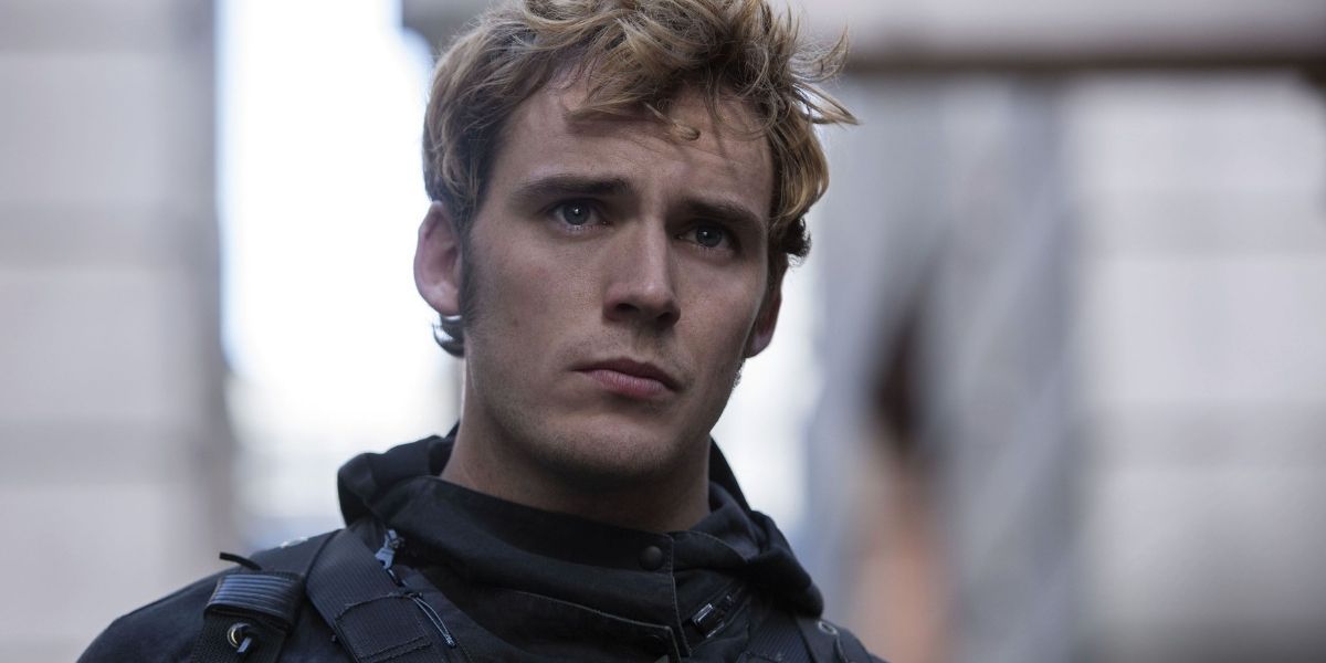 A close-up of Finnick Odair wearing a black military outfit in The Hunger Games Mockingjay Part 2