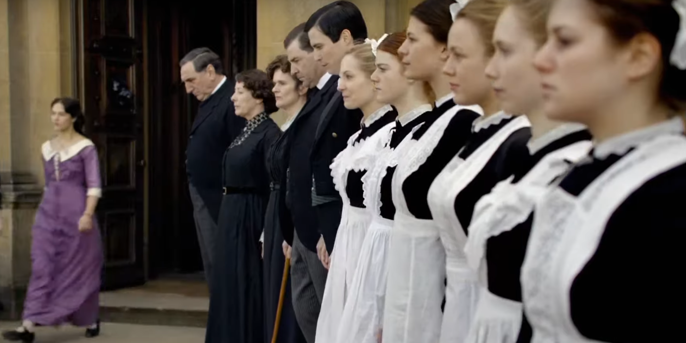 Servants lined up in front of the house in Downton Abbey