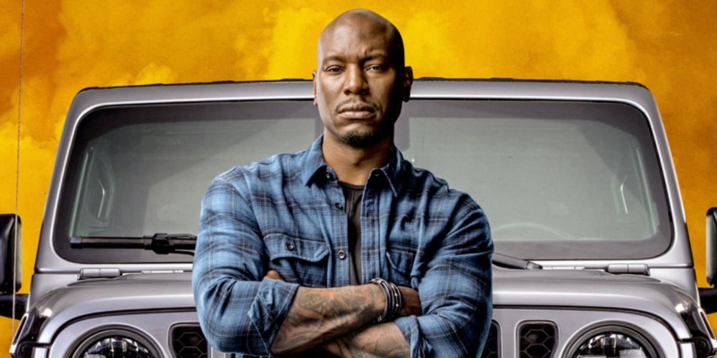  Roman Pearce (Tyrese Gibson) from Fast and the Furious has his arms crossed in front of a car.