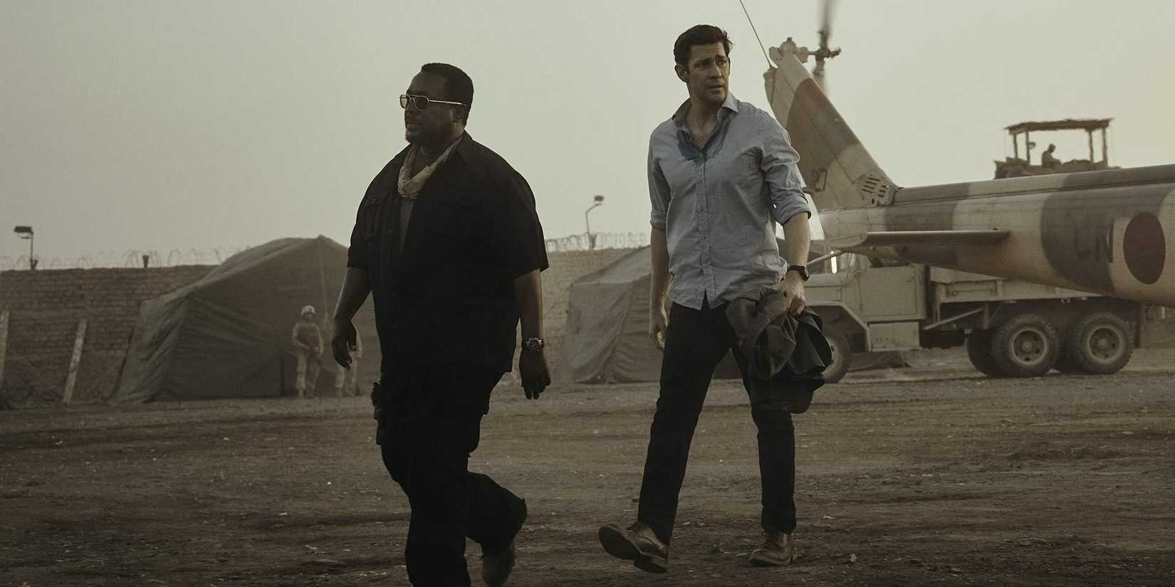 Wendell Pierce like James Greer and John Krasinski walking together in Jack Ryan by Tom Clancy