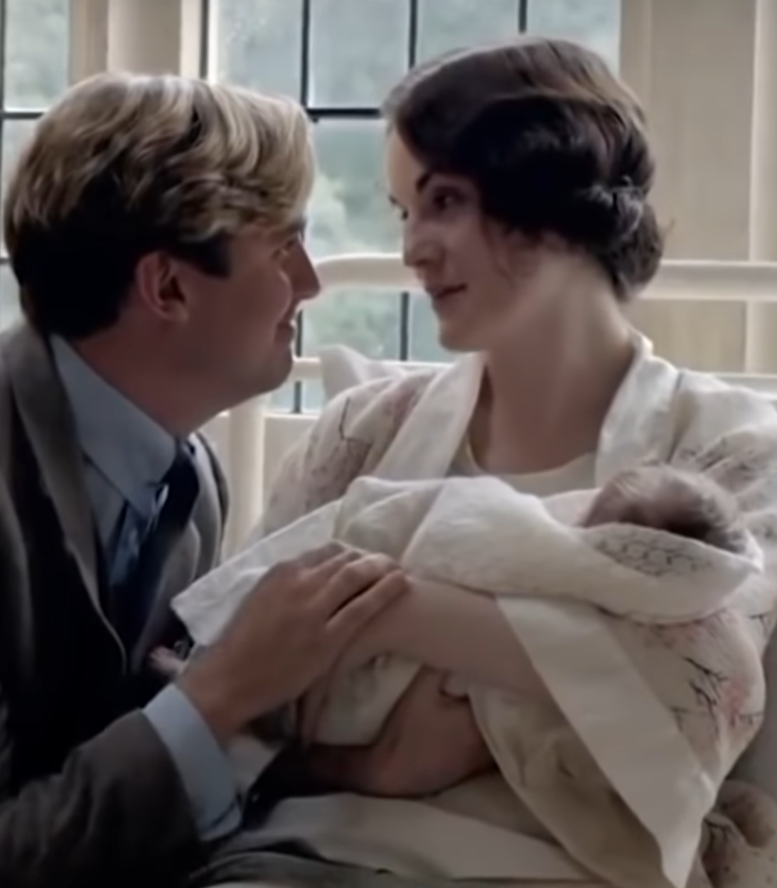 Mary Matthew looking at each other while she holds a baby in Downton Abbey
