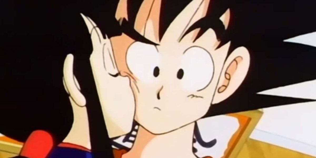 Chichi kisses a very confused Goku
