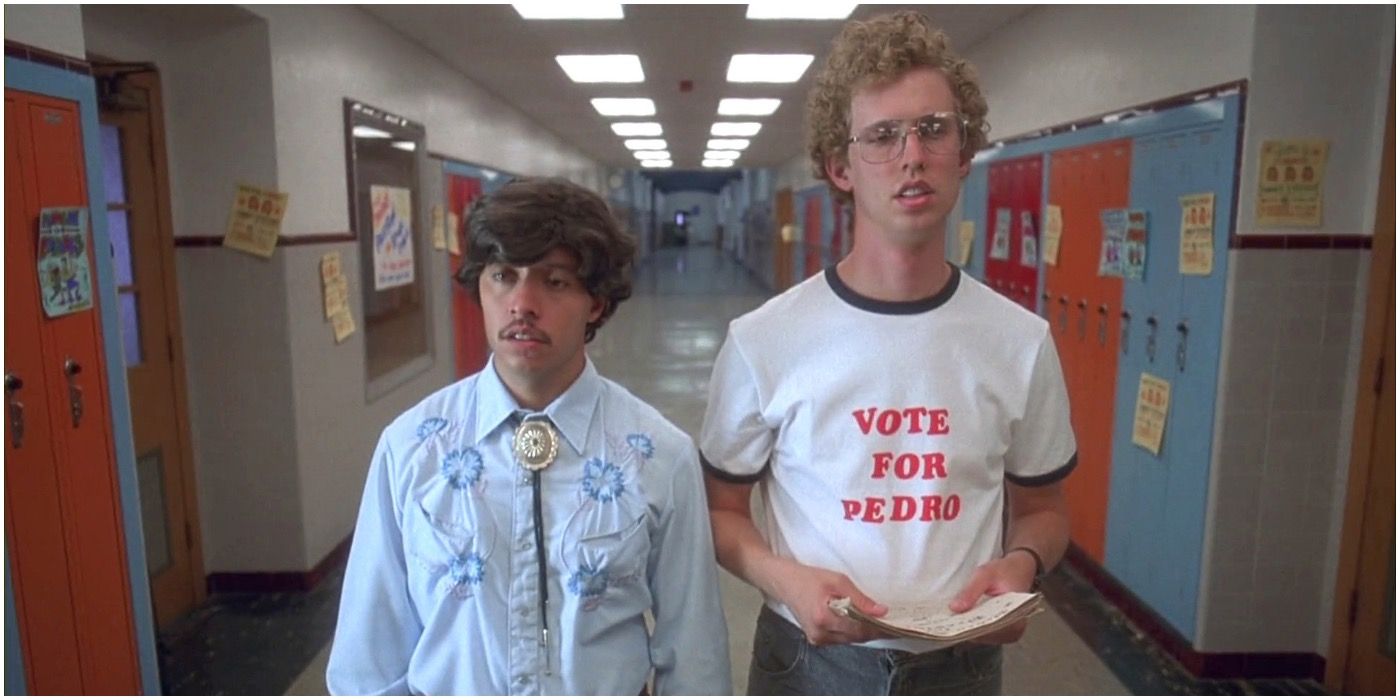 Napoleon Dynamite wearing a Vote For Pedro t-shirt walking down the hall with Pedro.