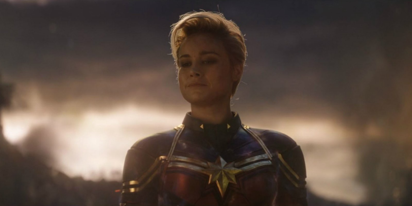 Captain Marvel smiles in Avengers: Endgame with a cloudy sky behind her