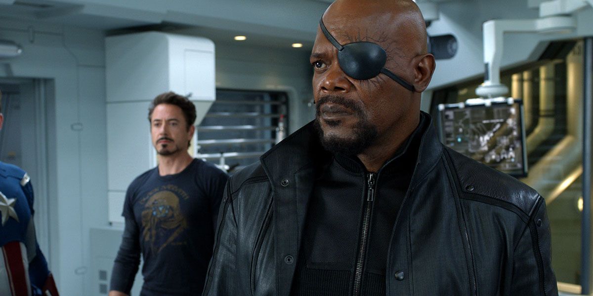Nick Fury stands with Iron Man and Captain America