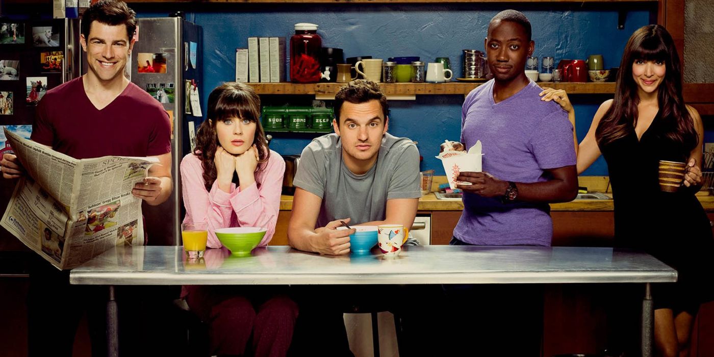 The cast of New Girl poses in the kitchen of the loft