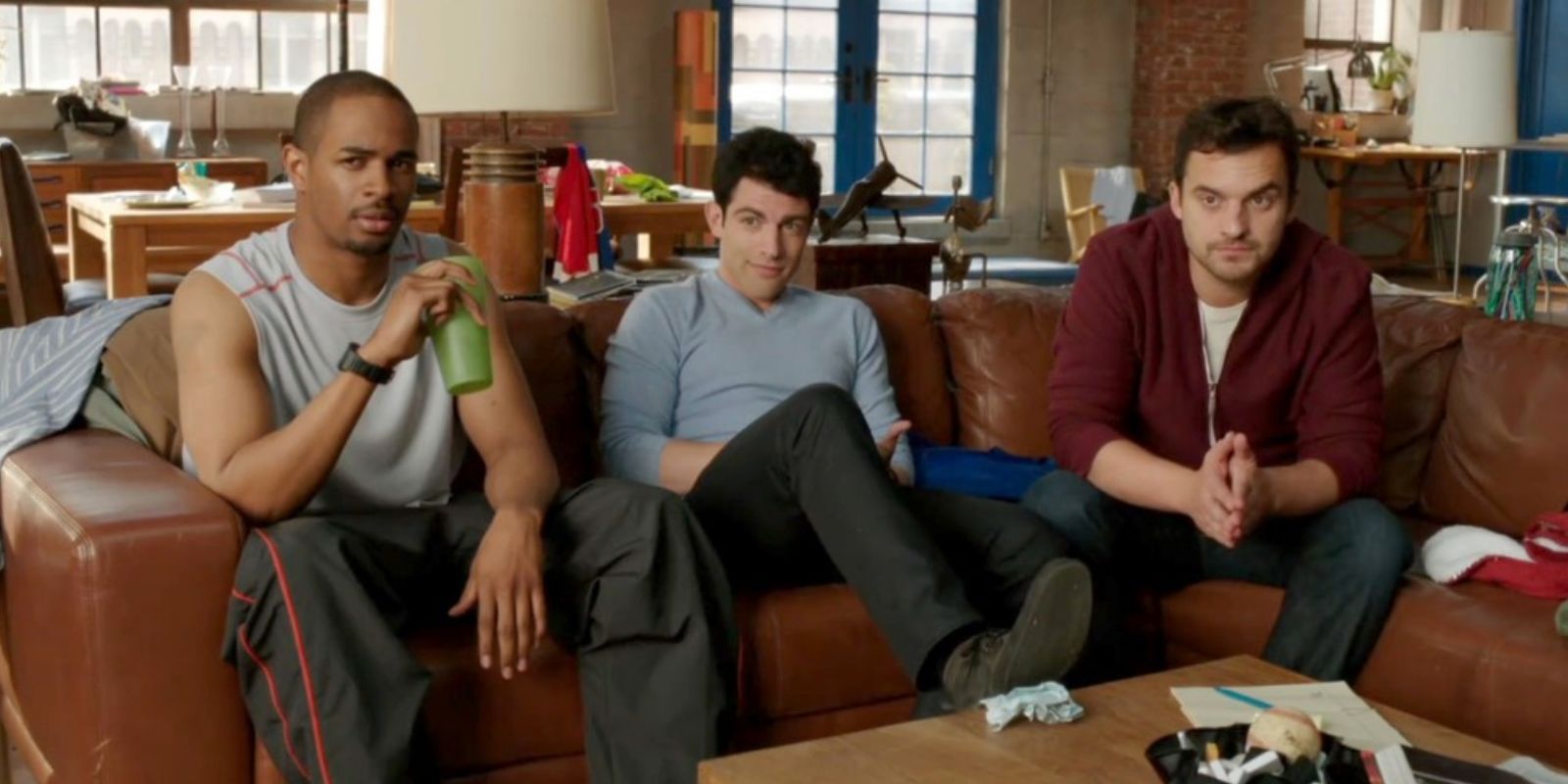 Coach (Damon Wayans Jr.), Schmidt (Max Greenfield), and Nick (Jake Johnson) in New Girl sitting on the couch on the couch in the New Girl pilot