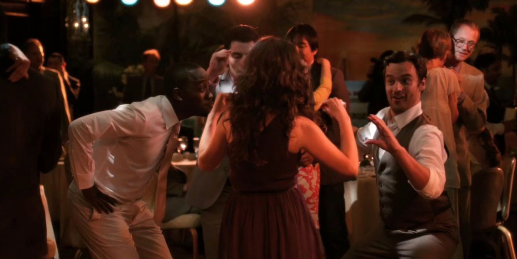The roommates dance together at the first wedding they attend in New Girl