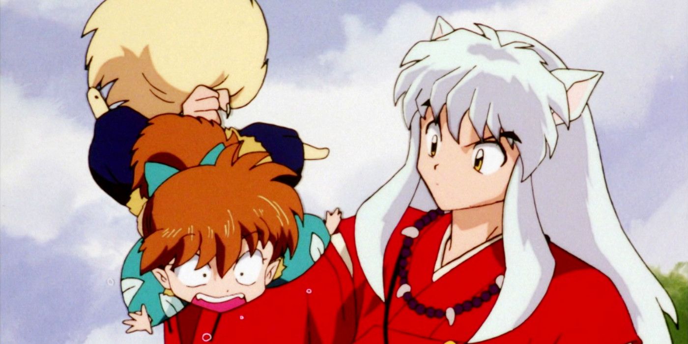 Inuyasha holding Shippo by the tail