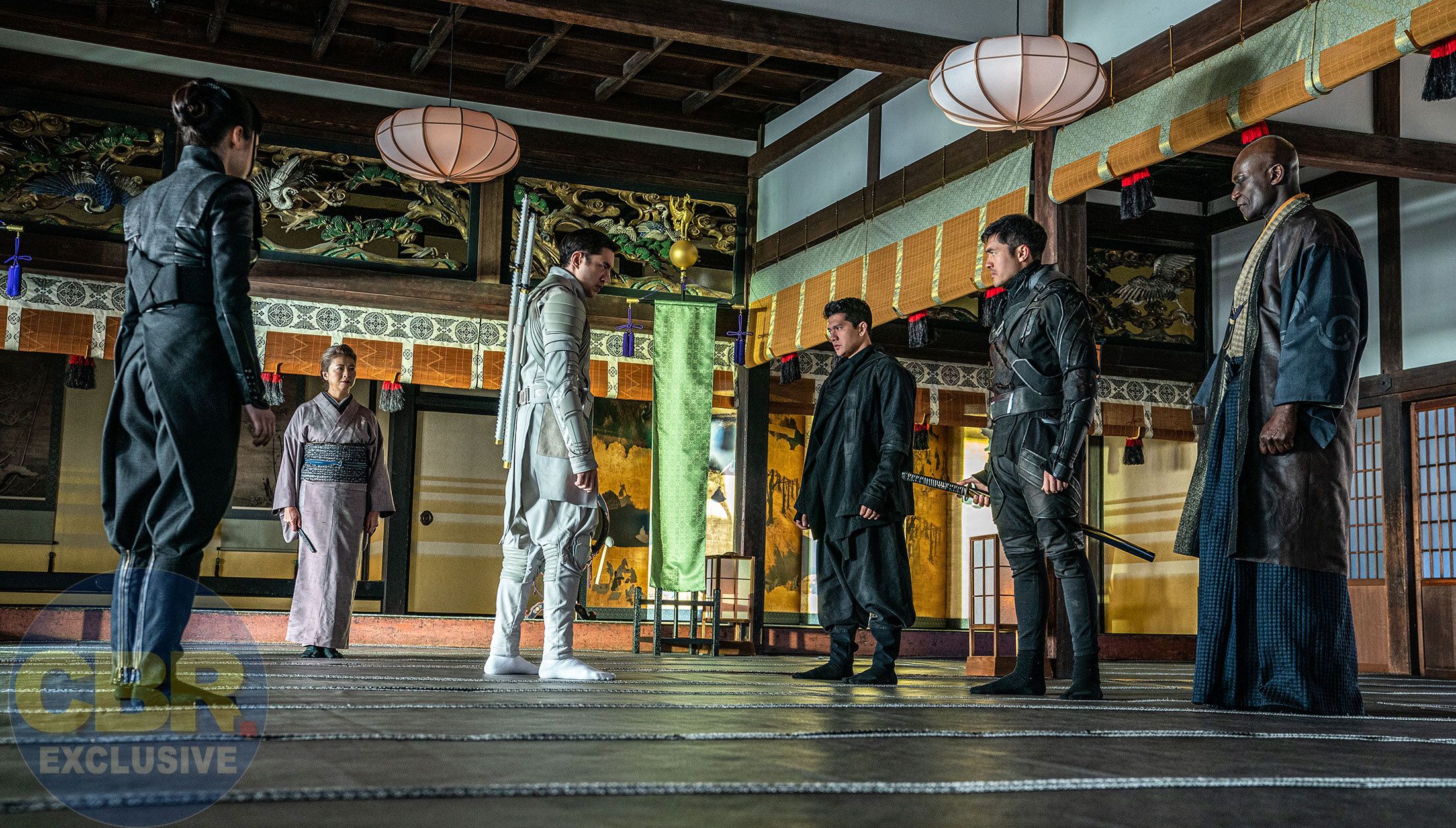 Snake Eyes engages in a staredown with Storm Shadow (Andrew Koji), while Hard Master (Iko Uwais) and Blind Master (Peter Mensah) flank him on either side.